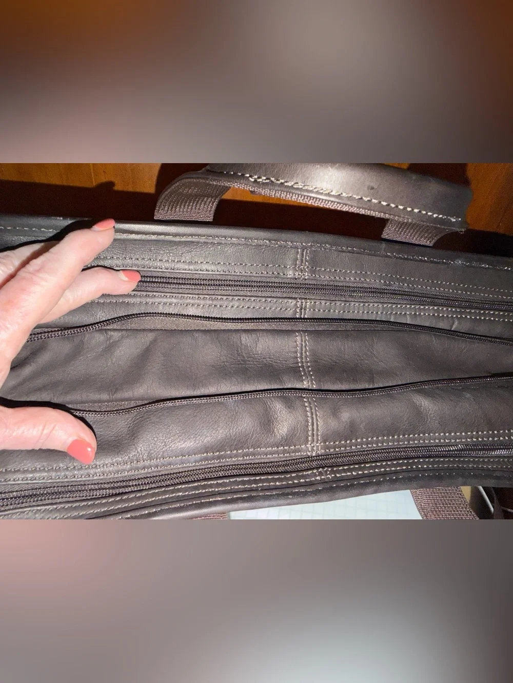 Wilson Leather dark brown leather expandable multi pocket laptop travel bag.